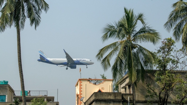 An aircraft operated by IndiGo, a unit of InterGlobe Aviation Ltd., prepares to land at Netaji Subhas Chandra Bose International Airport in Kolkata, India, on Sunday, Dec. 6, 2020. The pandemic continues to destroy global aviation, with countries closing borders, companies slashing travel budgets and tourists deferring trips indefinitely. Photographer: Arko Datto/Bloomberg