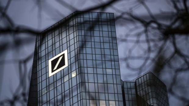 A logo sits on the Deutsche Bank AG headquarters at dawn in Frankfurt, Germany, on Tuesday, Dec. 10, 2019. Deutsche Bank said revenue from fixed-income trading is up this quarter while warning that its mid-term profitability goal is now “more ambitious” given the outlook for interest rates. Photographer: Alex Kraus/Bloomberg