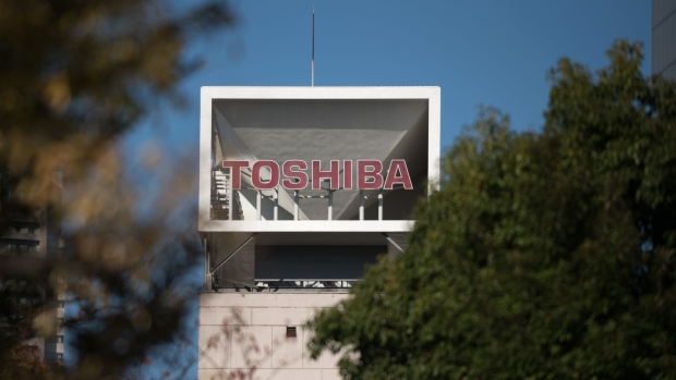 Signage for Toshiba Corp. is seen at the company's headquarters in Tokyo, Japan, on Thursday, Nov. 9, 2017. Toshiba is speeding up investments into a new flash-memory plant even as participation of its joint venture partner Western Digital Corp. remains unclear, ratcheting up the pressure on its U.S. counterpart to resolve a legal spat between two companies. Photographer: Akio Kon/Bloomberg