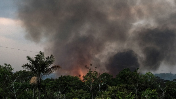Smoke rises during a fire close to the Madeira River in the Amazon rainforest near Porto Velho, Rondonia state, Brazil, on Sunday, Aug. 25, 2019. The world's largest rainforest, Brazil's Amazon, is burning at a record rate, according to data from the National Institute of Space Research that intensified domestic and international scrutiny of President Jair Bolsonaro's environmental policies. Photographer: Leonardo Carrato/Bloomberg
