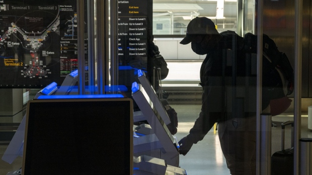 A traveler wearing a protective mask uses an automated kiosk to check-in at the Delta Air Lines Inc. check-in area at San Francisco International Airport (SFO) in San Francisco, California, U.S., on Monday, Dec. 21, 2020. Airline passenger numbers in the U.S. totaled 1.06 million on Dec. 20, compared with 2.52 million the same weekday a year earlier, according to the Transportation Security Administration.