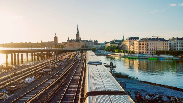 A train travels along railway tracks towards Gamla Stan in Stockholm, Sweden, on Thursday, Aug. 6, 2020. Sweden was unable to escape its worst economic contraction ever despite adopting one of Europe’s softest approaches to the Covid-19 pandemic. Photographer: Erika Gerdemark/Bloomberg