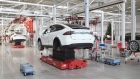 Tesla Model X sports utility vehicles (SUV) stand on hydraulic platforms during assembly for the European market at the Tesla Motors Inc. factory in Tilburg, Netherlands, on Friday, Dec. 9, 2016. A boom in electric vehicles made by the likes of Tesla could erode as much as 10 percent of global gasoline demand by 2035, according to the oil industry consultant Wood Mackenzie Ltd. Photographer: Jasper Juinen/Bloomberg