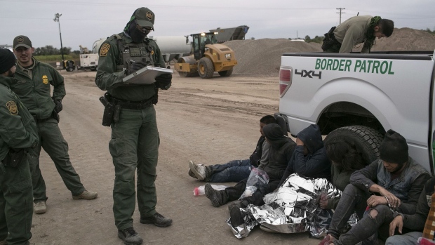 MISSION, TEXAS - DECEMBER 11: U.S. Border Patrol agents detain undocumented immigrants who they caught near the construction site of a privately-built border wall on December 11, 2019 near Mission, Texas. The hardline immigration group We Build The Wall is funding construction of the wall on private land along the Rio Grande, which forms the border with Mexico. The group, led by former Trump strategist Stephen Bannon claims to have raised tens of millions of dollars in a GoFundMe drive to build sections of wall along stretches of the southwest border with Mexico. (Photo by John Moore/Getty Images) Photographer: John Moore/Getty Images North America