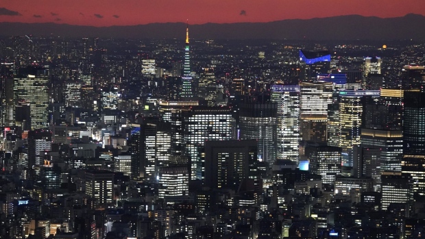 Tokyo Tower, middle, and buildings are lit up in Tokyo, Japan, on Friday, Dec. 25, 2020. Japan's infrastructure is already one of the world’s safest and investment in mitigating natural disasters is ramping up. Photographer: Toru Hanai/Bloomberg