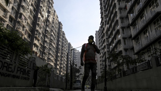 A pedestrian walks in a Godrej Properties Ltd. residential housing complex in the Chembur suburb of Mumbai, India, on Friday, Dec. 4, 2020. Home sales in India's commercial capital jumped to an eight year high in October, according to data from Knight Frank, marking an abrupt turnaround for a market that's spent three years in the doldrums after a prolonged shadow banking crisis strangled access to credit. Photographer: Dhiraj Singh/Bloomberg