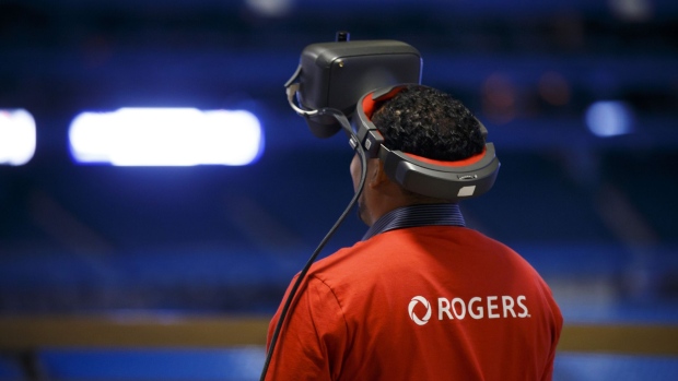 A Rogers Communications Inc. employee wears a virtual reality (VR) headset during a demonstration of 5G wireless network technology in Toronto, Ontario, Canada, on Monday, April 16, 2018. Chief Technology Officer Jorge Fernandes said that 5G networks probably won't to be ready for prime time until about 2020 while hardware and software is developed.
