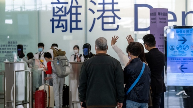 People wave in the departures hall at the Hong Kong International Airport in Hong Kong, China, on Tuesday, Jan. 26, 2021. Hong Kong no longer has the busiest airport for international traffic in Asia after the coronavirus pandemic wiped out travel, leaving South Korea's Incheon International Airport in top spot, albeit with drastically fewer numbers than previous years.