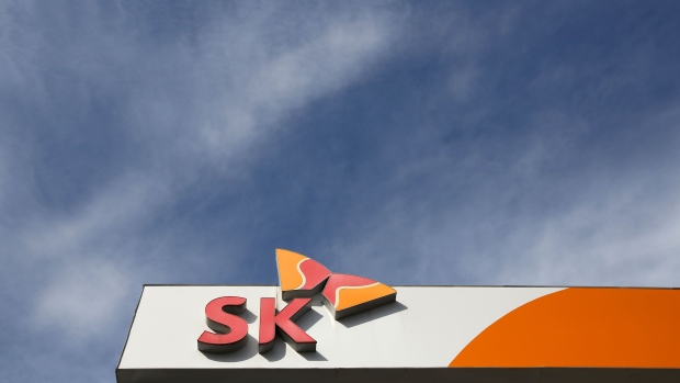 The SK group logo stands atop of an SK Energy Co. gas station, a unit of SK Innovation Co., in Incheon, South Korea, on Tuesday, Jan. 31, 2017. SK Innovation is scheduled to announce fourth quarter earnings on Feb. 3. Photographer: SeongJoon Cho/Bloomberg