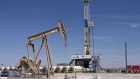 A pumpjack operates near a Nabors Industries Ltd. drill rig standing over an oil well for Chevron Corp. in the Permian Basin near Midland, Texas, U.S., on Thursday, March 1, 2018. Chevron, the world's third-largest publicly traded oil producer, is spending $3.3 billion this year in the Permian and an additional $1 billion in other shale basins. Its expansion will further bolster U.S. oil output, which already exceeds 10 million barrels a day, surpassing the record set in 1970.