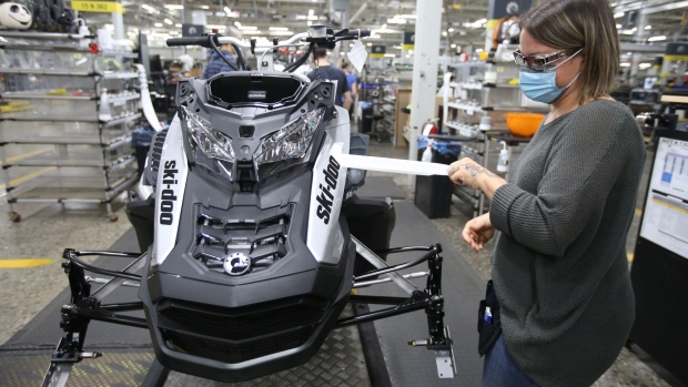 Workers wearing protective masks assemble a Ski-Doo brand snowmobile at a BRP manufacturing facility in Valcourt, Quebec, Canada, on Wednesday, Oct. 28, 2020.