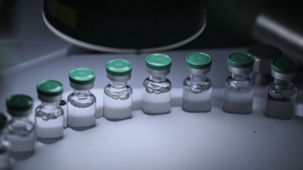 Vials of Covishield, the local name for the Covid-19 vaccine developed by AstraZeneca Plc. and the University of Oxford, move along a conveyor on the production line at the Serum Institute of India Ltd. Hadaspar plant in Pune, Maharashtra, India, on Friday, Jan. 22, 2021. Serum, which is the world's largest vaccine maker by volume, has an agreement with AstraZeneca to produce at least a billion doses.