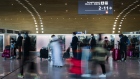 Travelers pass through the check-in hall at Charles de Gaulle airport, operated by Aeroports de Paris, in Roissy, France, on Friday, Dec. 18, 2020. The rollout of vaccines against Covid-19 has intensified debate about whether they should be made mandatory, with the head of a major tourism lobby saying that doing so would cause irreparable harm to the struggling sector. Photographer: Nathan Laine/Bloomberg