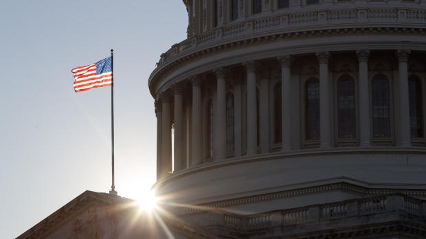 An American flag flies outside the U.S. Capitol building in Washington, D.C., U.S. on Tuesday, Dec. 29, 2020. Senate Majority Leader Mitch McConnell blocked an attempt by Democrats to force quick action on increasing direct stimulus payments to $2,000 despite President Donald Trump’s demands for the change. Photographer: Ting Shen/Bloomberg