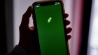 The Robinhood logo on a smartphone arranged in the Brooklyn borough of New York, U.S., on Friday, Dec. 18, 2020. Robinhood Markets will pay $65 million to settle allegations that it failed to properly inform clients it sold their stock orders to high-frequency traders and other firms, putting a major compliance headache behind the brokerage even as new ones emerge. Photographer: Gabby Jones/Bloomberg