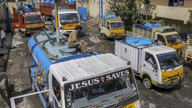 Empty water pots, left to be refilled by a water truck, line a residentil street in Chennai, on July 4, 2019. Photographer: Dhiraj Singh/Bloomberg
