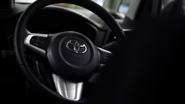 A Toyota Motor Corp. badge is displayed on the steering wheel of a vehicle inside the Toyota City Showcase exhibit at the company's Mega Web car theme park in Tokyo, Japan, on Friday, Feb. 3, 2017. Toyota is scheduled to report third-quarter earnings figures on Feb. 6. Photographer: Kiyoshi Ota/Bloomberg