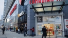 Customers stand in line for curb-side pickup at a Canadian Tire Corp. store in Toronto, Ontario, Canada, on Thursday, Jan. 14, 2021. Ontario's government declared a second provincial emergency and imposed more restrictions as Covid-19 rates accelerate and a new variant of the virus emerges in Canada’s most populous province.