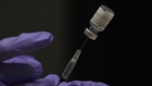 A pharmacist prepares a syringe of the Pfizer BioNtech Covid-19 vaccine in Tucson, Arizona, U.S., on Friday, Jan. 15, 2021. 