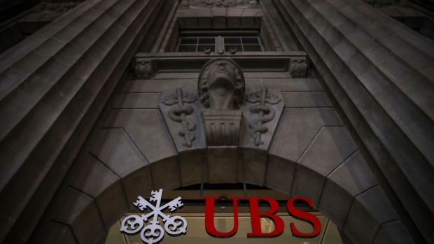 The UBS Group AG logo above the entrance to the company's headquarters in Zurich, Switzerland, on Tuesday, Jan. 26, 2021. UBS plans to buy back as much as 4 billion francs ($4.5 billion) of shares over the next three years, bolstering shareholder returns after income from managing client assets and investment banking propelled gains at the world’s largest wealth manager.