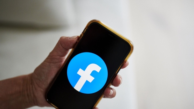 The logo for Facebook is displayed on a smartphone in an arranged photograph taken in Little Falls, New Jersey, U.S., on Wednesday, Oct. 7, 2020. Facebook Inc. is tightening its rules on content concerning the U.S. presidential election next month, including instituting a temporary ban on political ads when voting ends, as it braces for a contentious night that may not end with a definitive winner. Photographer: Gabby Jones/Bloomberg