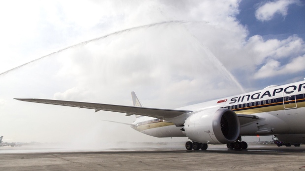 A Boeing Co. 787-10 Dreamliner aircraft, operated by Singapore Airlines Ltd., receives a water cannon salute as it arrives at Changi Airport in Singapore, on Wednesday, March 28, 2018. In May, Osaka and Perth will be first scheduled destinations for the airline's new 787-10s.