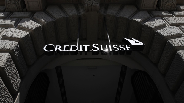 A logo hangs above the entrance to the Credit Suisse Group AG headquarters in Zurich, Switzerland, on Friday, April 17, 2020. Credit Suisse compensated managers and employees with additional shares in the bank after the price dropped sharply during the depths of a market correction spurred by the coronavirus outbreak. Photographer: Stefan Wermuth/Bloomberg