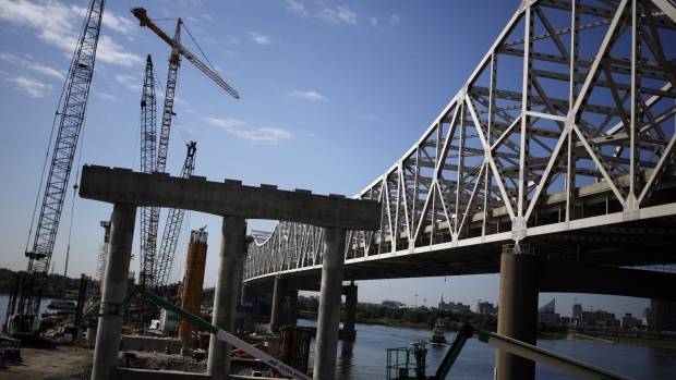 Construction crews work to erect a new highway bridge to carry I-65 traffic across the Ohio River from Louisville, Kentucky.