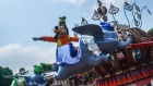 An actor dressed as Goofy rides the Dumbo the Flying Elephant attraction in Fantasyland at Walt Disney Co.'s Disneyland Resort during its reopening in Hong Kong.