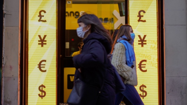 Pedestrians pass a currency exchange in Madrid, Spain, on Friday, Dec. 4, 2020. The pound rallied on mounting speculation that Britain and the European Union are closing in on a Brexit trade agreement. Photographer: Paul Hanna/Bloomberg