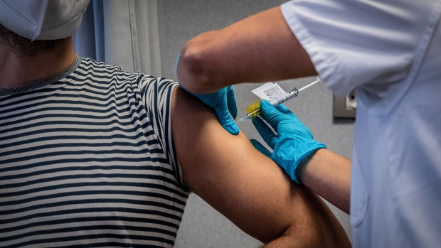 A medical worker administers an injection to a volunteer during a phase 3 trial of the Johnson & Johnson Covid-19 vaccine by the Germans Trias i Pujol hospital and Foundation for the Fight against AIDS and Infectious Diseases, in the Badalona district of Barcelona, Spain, on Thursday, Dec. 17, 2020. Johnson & Johnson is in the midst of stage three trials, including one in South Africa, for its vaccine. Photographer: Angel Garcia/Bloomberg