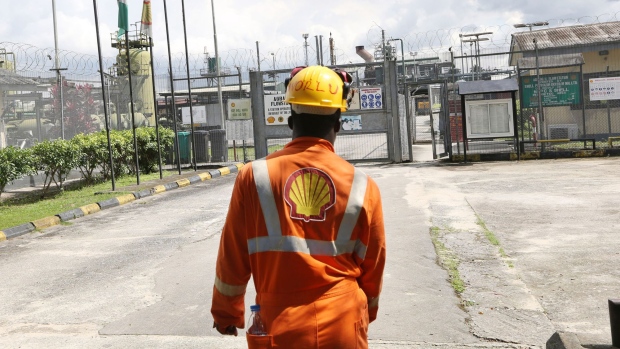 An employee approaches the entrance to the Agbada 2 oil flow station, operated by Shell Petroleum Development in Port Harcourt, Nigeria.