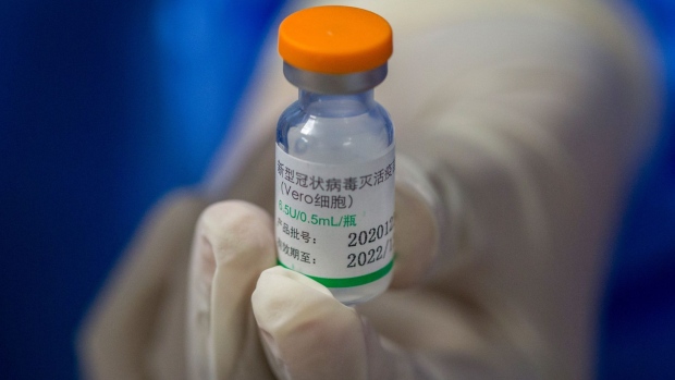 A health worker handles a vial of the Sinopharm Group Co. Covid-19 vaccine in the Adult Vaccination Center at the Dow University Hospital in Karachi, Pakistan, on Wednesday, Feb. 3, 2021. Pakistan has granted approval to Russia’s Sputnik V vaccine according to people familiar with the matter. The South Asian country has already ordered 1.2 million doses from Chinese state-backed vaccine developer Sinopharm, and has also given approval to AstraZeneca Plc’s shot for private use. Photographer: Asim Hafeez/Bloomberg