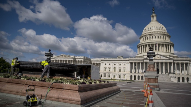 Workers clean outside of the U.S. Capitol in Washington, D.C., U.S., on Tuesday, May 12, 2020. Lawmakers continue negotiations over the next round of coronavirus stimulus legislation, with a Senate Democrat saying today that a handful of Republicans could be on board with a proposal to send $500 billion in funding to states. Photographer: Eric Thayer/Bloomberg