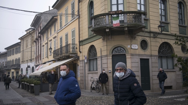 CODOGNO, ITALY - FEBRUARY 21: People wearing protective masks walk through the city center on February 21, 2021 in Codogno, Italy. A memorial for the victims of coronavirus will be inaugurated in Codogno to commemorate the one year anniversary since the discovery of what was thought to be the first patient to test positive for COVID-19 in Italy. (Photo by Stefano S. Guidi/Getty Images)