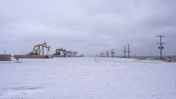 Pumpjacks operate in the snow in the Permian Basin in Midland, Texas, U.S, on Saturday, Feb. 13, 2021.