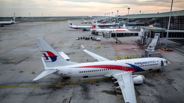 Malaysian Airlines Bhd. and Malindo Airways aircraft stand on the tarmac at Kuala Lumpur International Airport (KLIA) in Sepang, Selangor, Malaysia, on Tuesday, Jan. 17, 2017. The hunt for Malaysia Airlines Flight 370 was called off Jan. 17 after almost three years of fruitless toil. The Boeing Co. 777 aircraft disappeared on March 8, 2014, on its way to Beijing from Kuala Lumpur with 239 people on board. Photographer: Sanjit Das/Bloomberg