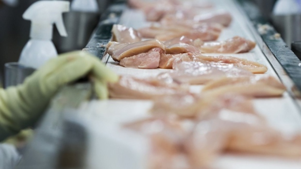 Pieces of chicken breast move along a conveyor at the Harim Co. factory in Iksan, South Korea, on Monday, June 29, 2015.