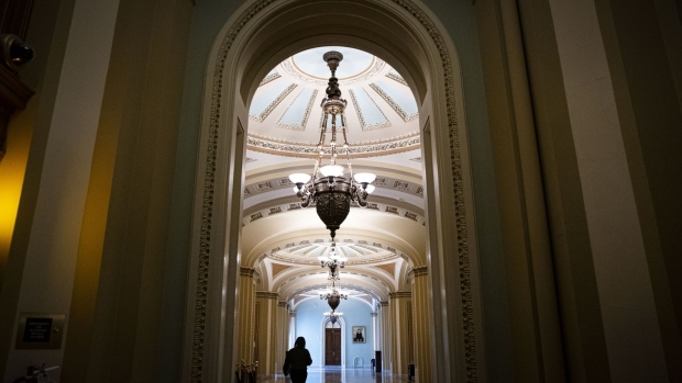 A congressional staff member walks through the U.S. Capitol in Washington, D.C., U.S., on Tuesday, Feb. 16, 2021. With Donald Trump's impeachment trial behind them, Democrats are quickly pivoting back to President Joe Biden's priorities, particularly his $1.9 trillion stimulus plan and confirming the rest of his cabinet. Photographer: Al Drago/Bloomberg