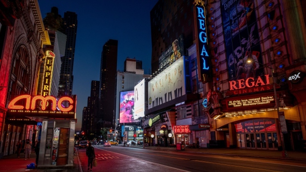 A Regal Cinemas movie theater stands at night on 42nd Street in New York.