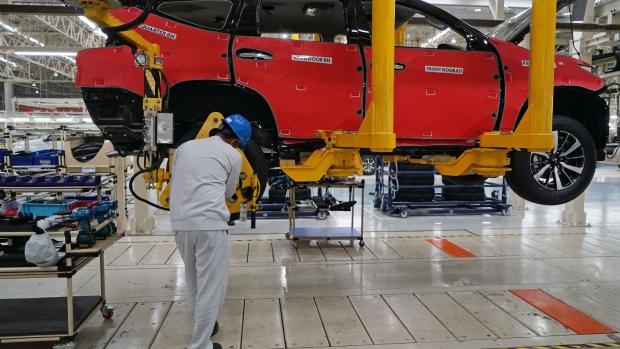 An employee works on the wheel of a Mitsubishi Motors Corp. sports utility vehicle (SUV) on a production line at the company's plant in Cikarang, Indonesia, on Tuesday, April 25, 2017. Mitsubishi Motors may supply its new multipurpose vehicle to Nissan Motor Co. in Indonesia by 2019, as the alliance partners explore ways to enhance cooperation and exploit synergies. Photographer: Dimas Ardian/Bloomberg
