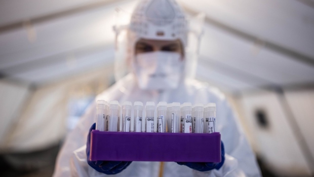 A health worker wearing personal protective equipment (PPE) handles a tray of swab samples at a drive-thru Covid-19 testing site in Prague, Czech Republic, on Wednesday, Feb. 17, 2021. Government parties in the Czech Republic, which is in the middle of one of the fastest-spreading and deadliest coronavirus outbreaks in Europe, are arguing over a plan to reopen shops and schools. Photographer: Milan Jaros/Bloomberg