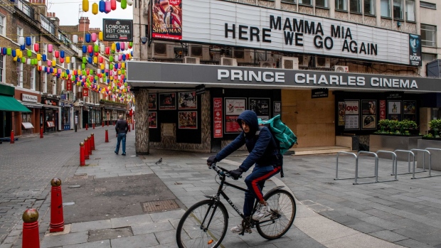 A Deliveroo cyclist passes a closed cinema on the edge of Chinatown and Leicester Square in London, U.K., on Friday, Jan. 15, 2021. Londoners have received one tenth of all vaccine shots administered in England, despite facing a crisis thats pushing the capitals hospitals to the brink of collapse. Photographer: Chris J. Ratcliffe/Bloomberg