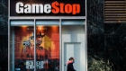 A pedestrian wearing a protective mask walks past a a GameStop Corp. store in the Herald Square area of New York, U.S., on Friday, Nov. 27, 2020.