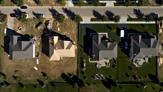 Houses under construction, left, stand next to completed homes at the Toll Brothers Inc. Bowes Creek Country Club community in this aerial photograph taken over Elgin, Illinois, U.S., on Wednesday, Sept. 26, 2018. U.S. construction spending inched up 0.1% in August. Photographer: Daniel Acker/Bloomberg