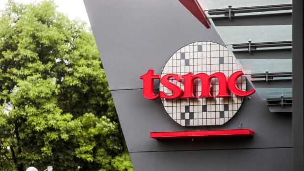 Signage is displayed at Taiwan Semiconductor Manufacturing Co. (TSMC) headquarters in Hsinchu, Taiwan, on Tuesday, July 28, 2020. TSMC kept up its record-breaking streak Tuesday, briefly becoming the world's 10th most valuable corporation before paring gains. Photographer: I-Hwa Cheng/Bloomberg