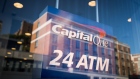 Buildings are reflected in the window of a Capital One bank branch in New York.