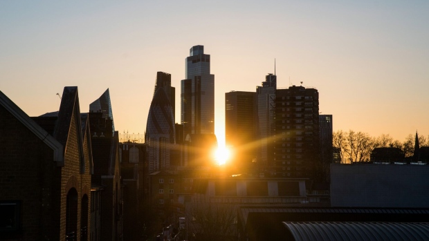 The sun sets behind skyscrapers in the City of London square mile financial district in London, U.K., on Thursday, Feb. 18, 2021. Amsterdam overtook London as Europe's largest share trading center in January after Brexit saw about half of the city's volumes move to the continent. Photographer: Chris Ratcliffe/Bloomberg