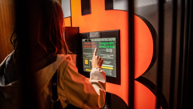 A customer uses a bitcoin automated teller machine in a kiosk Barcelona. Photographer: Angel Garcia/Bloomberg