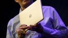 Sam Burd, president of client solutions at Dell Inc., holds a Dell XPS 13" laptop computer during the company's press conference at the 2018 Consumer Electronics Show (CES) in Las Vegas, Nevada, U.S., on Tuesday, Jan. 9, 2018. Electric and driverless cars will remain a big part of this year's CES, as makers of high-tech cameras, batteries, and AI software vie to climb into automakers' dashboards. Photographer: Patrick T. Fallon/Bloomberg